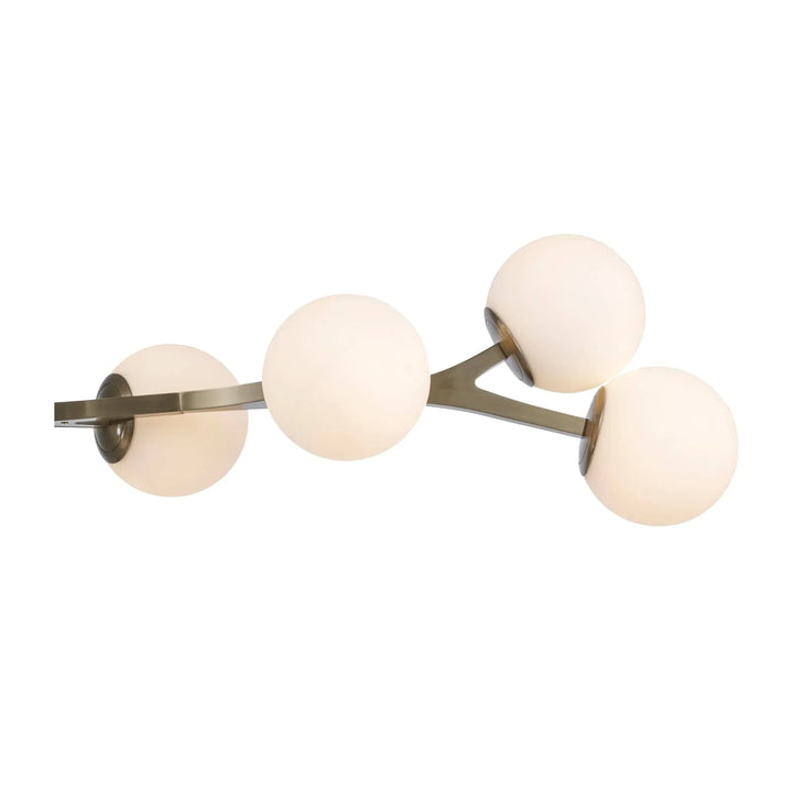 Modern pendant light with angled antique gold arms and round glass globes for interior lighting