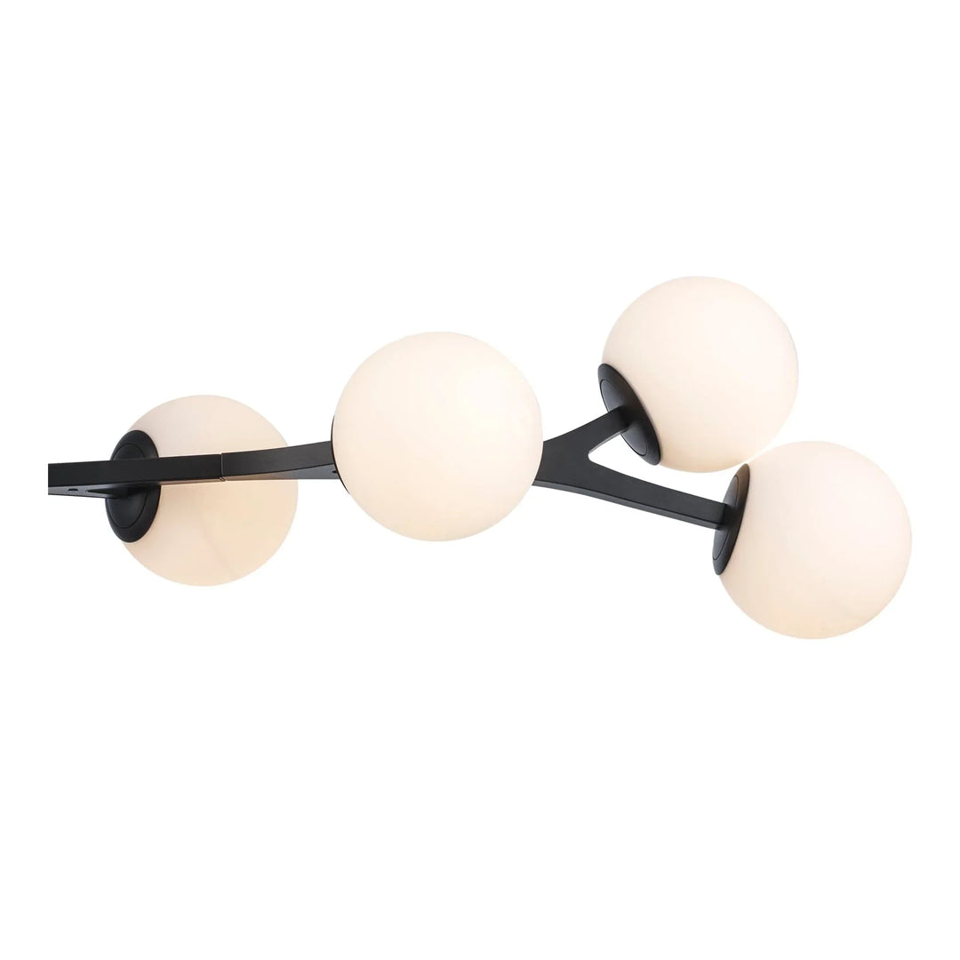 Modern LED pendant light with four white globe shades and black angled arms for living room lighting