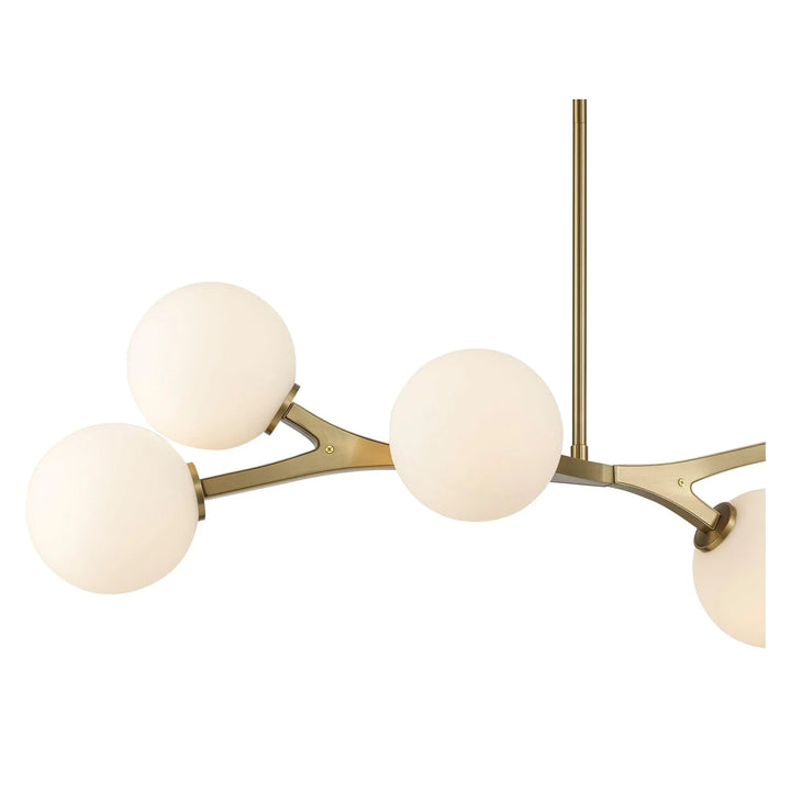 Modern 6-light chandelier with angled gold arms and white glass globes for indoor ceiling lighting